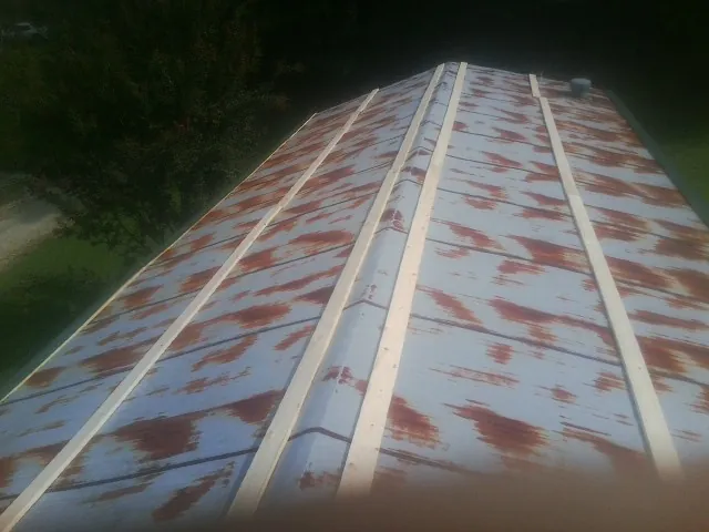 Rusted metal roof panels with new wood purlins before replacement — Storm Damage Roof Repair in Granbury by Roofing Brothers